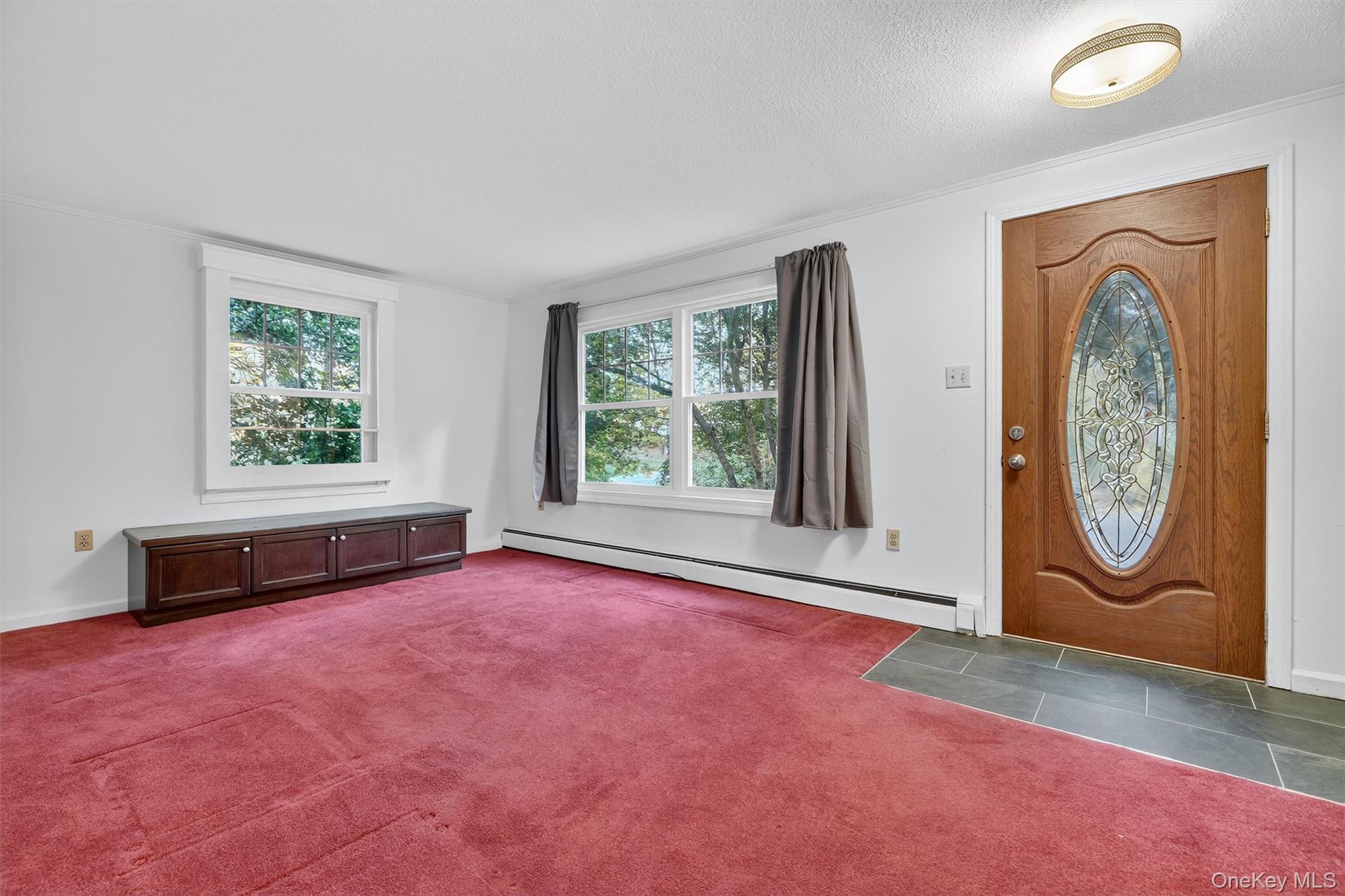 114 Laurel Hill Road Croton-on-Hudson, NY 10520 - Photo 4 of 34 an empty room with windows and fireplace