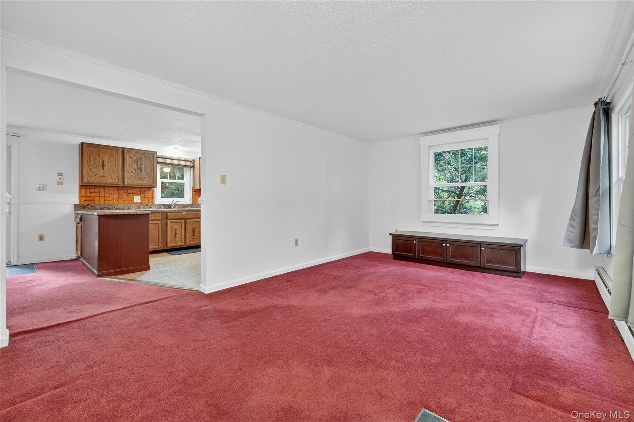 114 Laurel Hill Road Croton-on-Hudson, NY 10520 - Photo 5 of 34 an empty room with kitchen and wooden floor