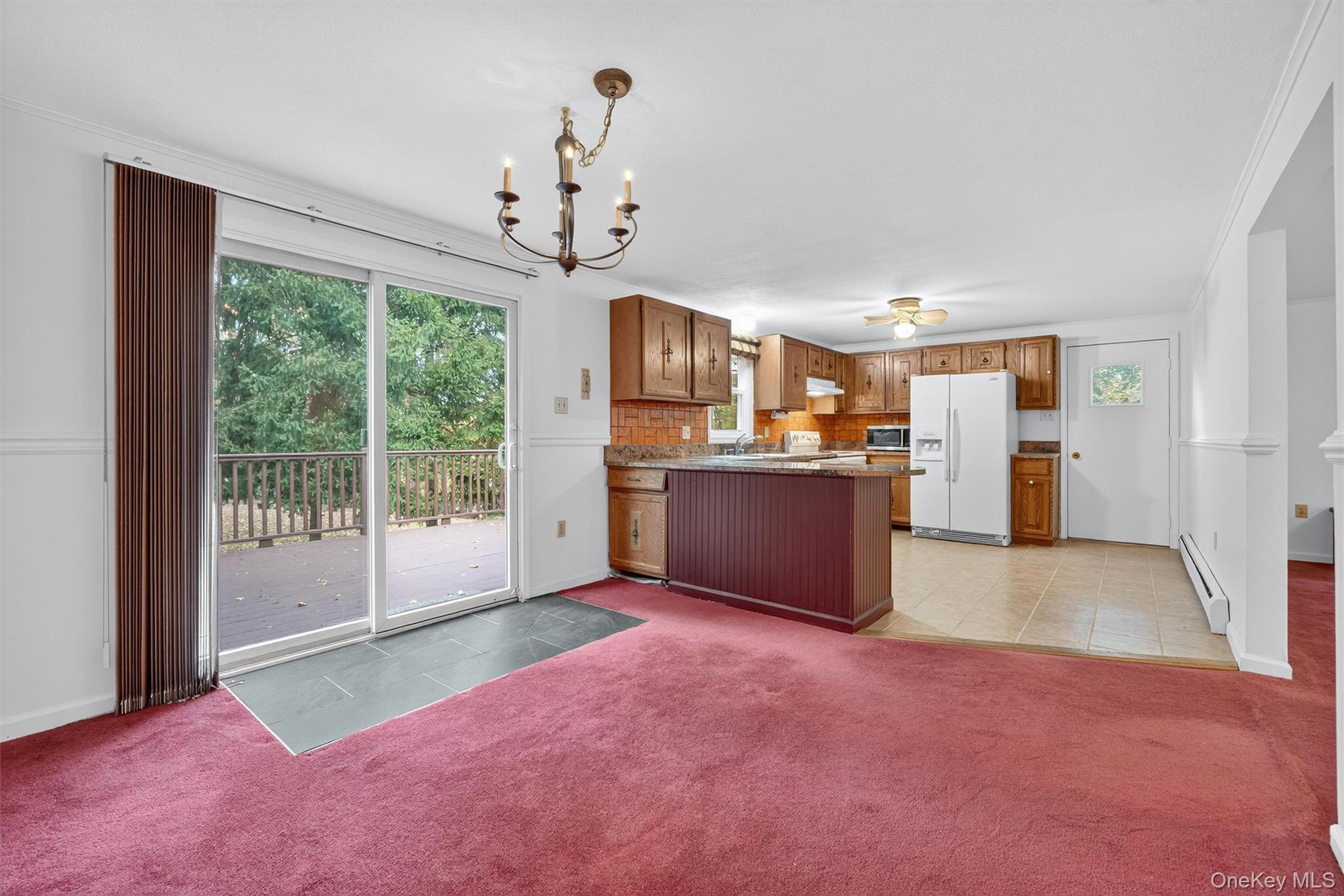 114 Laurel Hill Road Croton-on-Hudson, NY 10520 - Photo 8 of 34 a view of a kitchen with a sink wooden cabinets and a fireplace