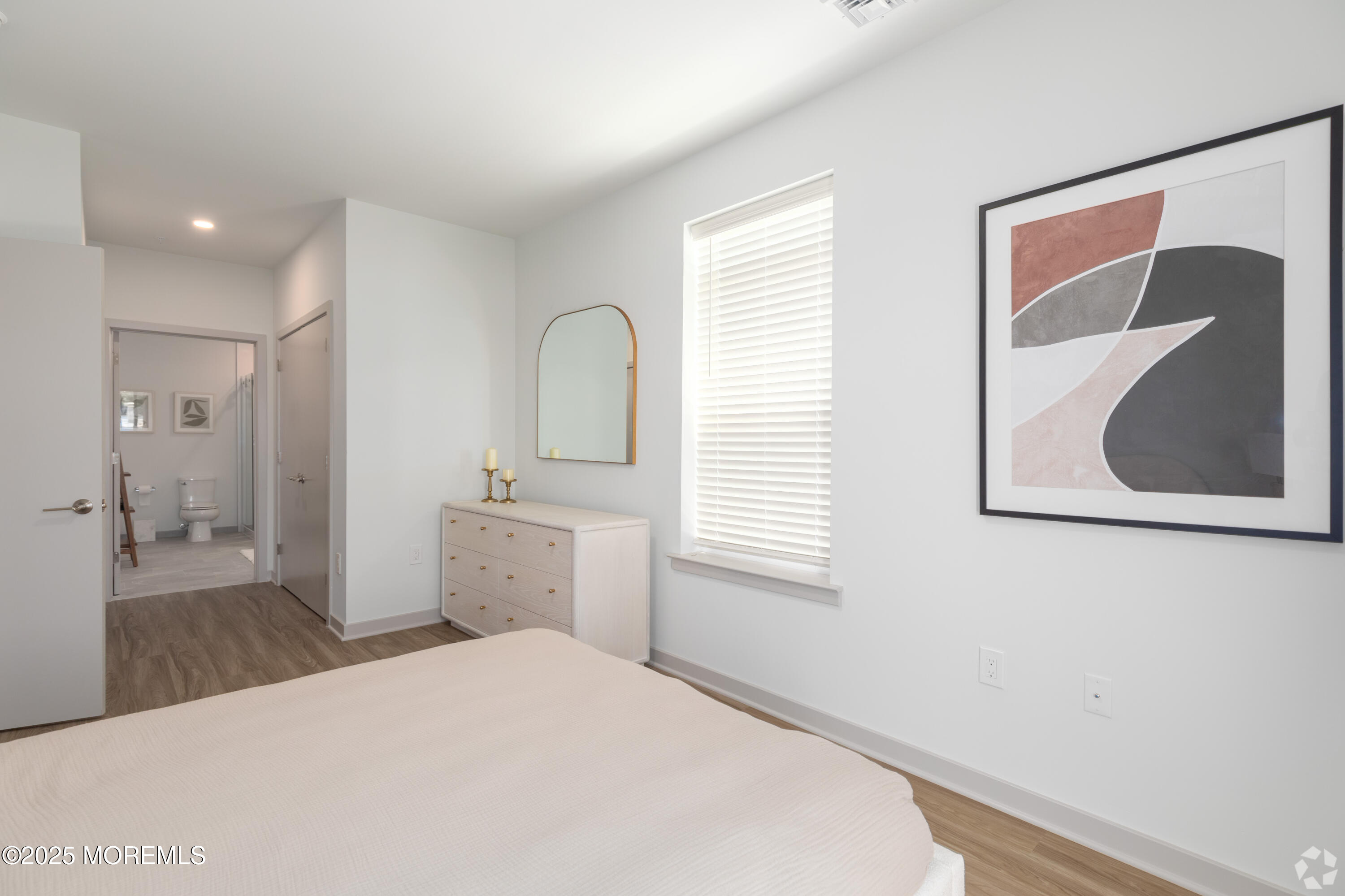 6461 Highway 9, Unit #112 Howell, NJ 07731 - Photo 4 of 13 a bedroom with a bed and a painting on the wall