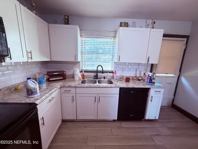 a kitchen with a sink stove and cabinets