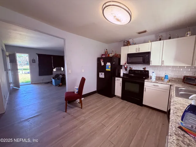 a view of kitchen with furniture and wooden floor