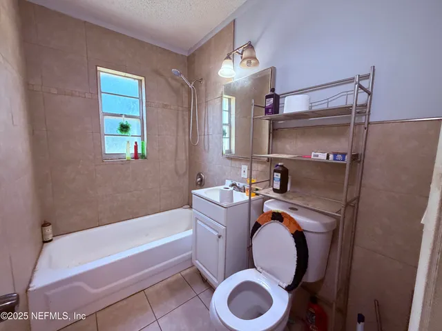 a bathroom with a sink mirror vanity and toilet