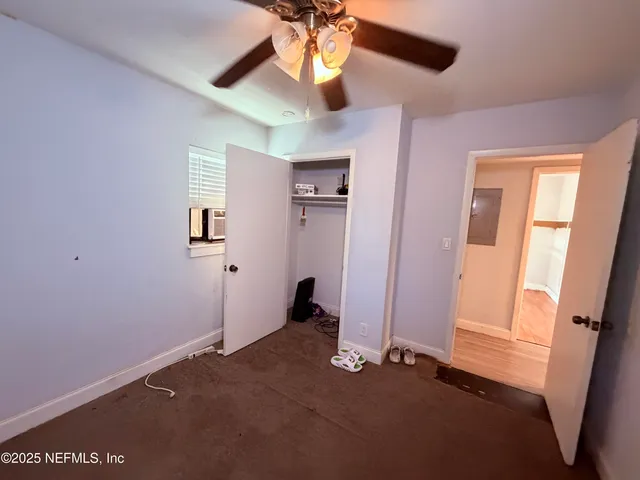 a view of a livingroom with a ceiling fan and window