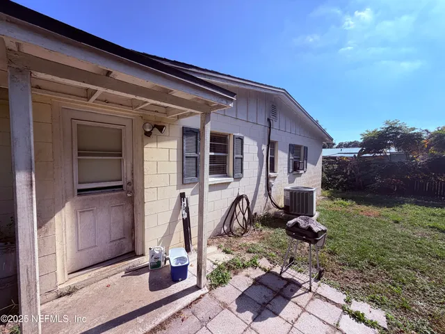 a view of house with backyard space and garden