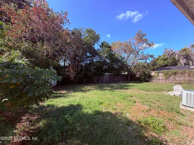 a backyard of a house with lots of green space