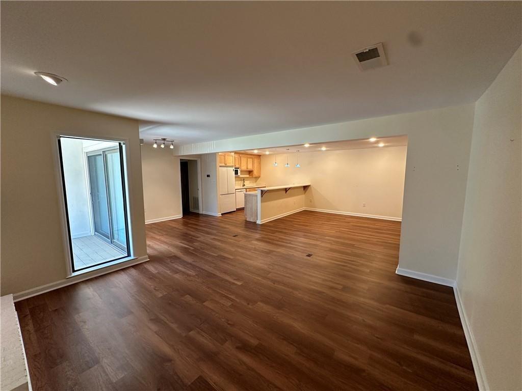 605 Candler Street, Unit C9 Gainesville, GA 30501 - Photo 3 of 18 wooden floor in an empty room with a window