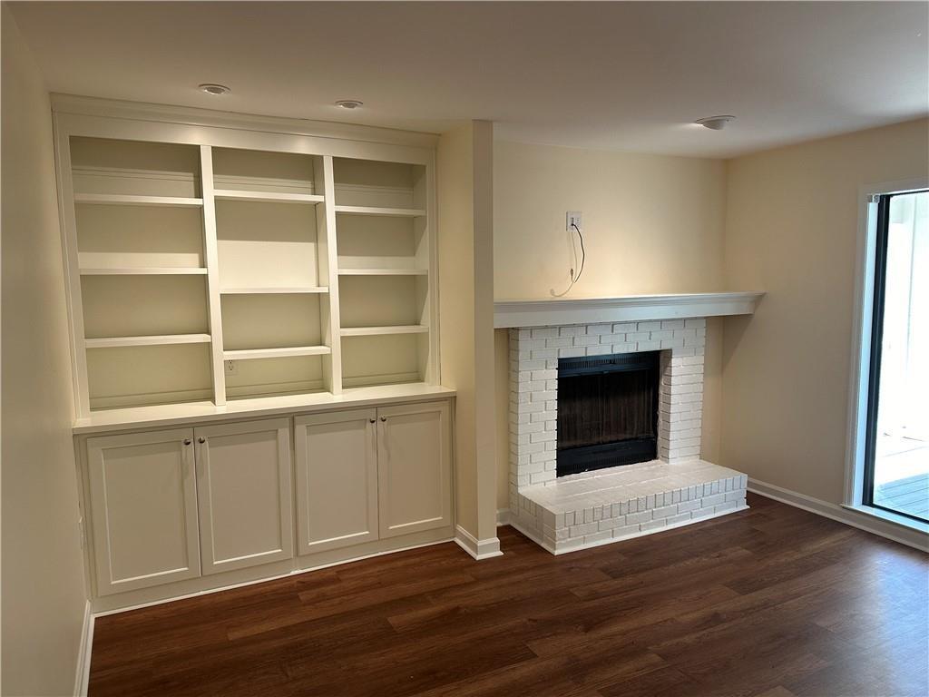 605 Candler Street, Unit C9 Gainesville, GA 30501 - Photo 6 of 18 a view of an empty room with a window and fireplace
