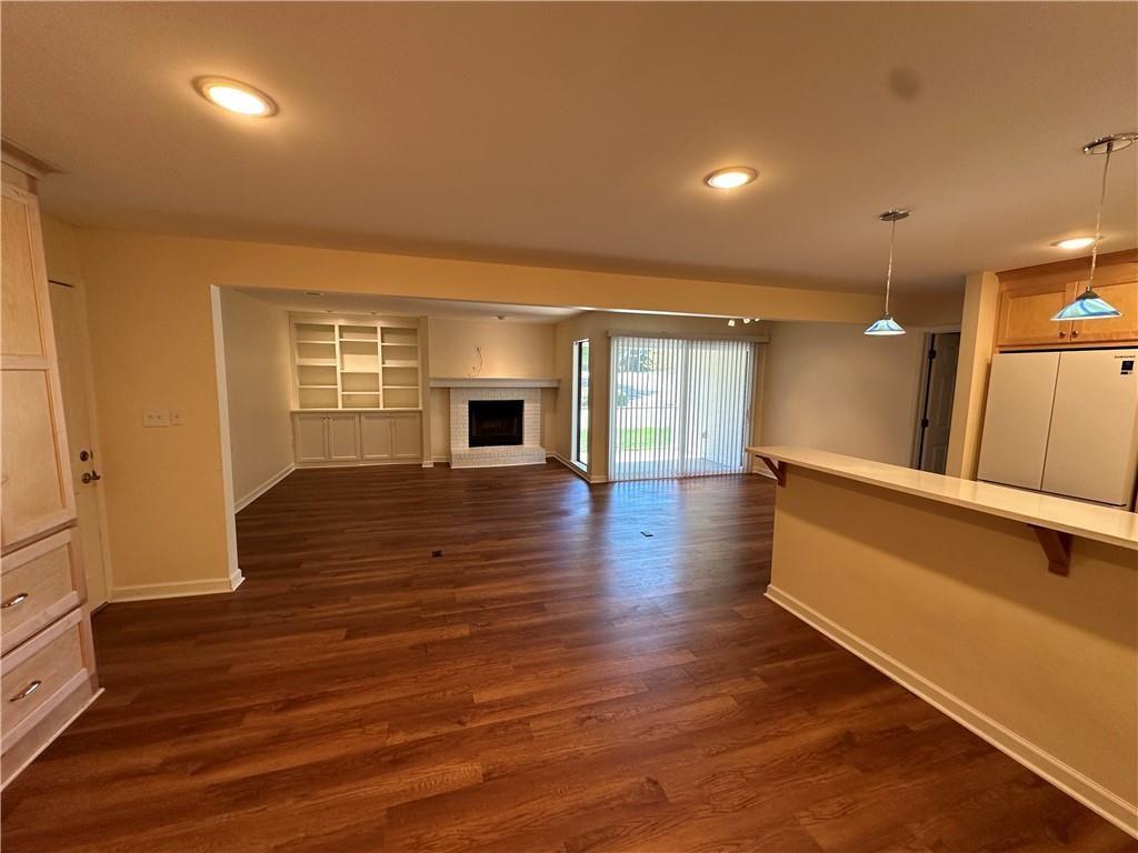 605 Candler Street, Unit C9 Gainesville, GA 30501 - Photo 7 of 18 an empty room with wooden floor and windows