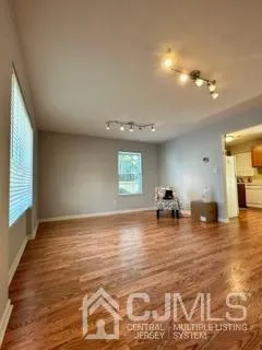 a view of a room window and wooden floor