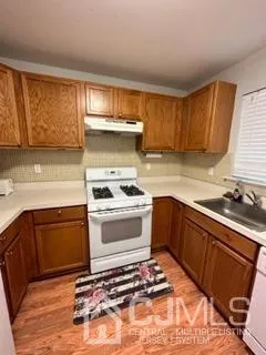 a kitchen with a stove a sink and a refrigerator