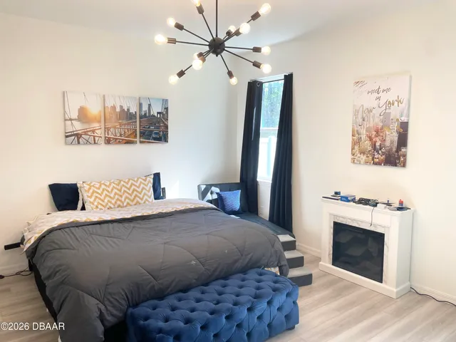 a bedroom with a bed and a ceiling fan