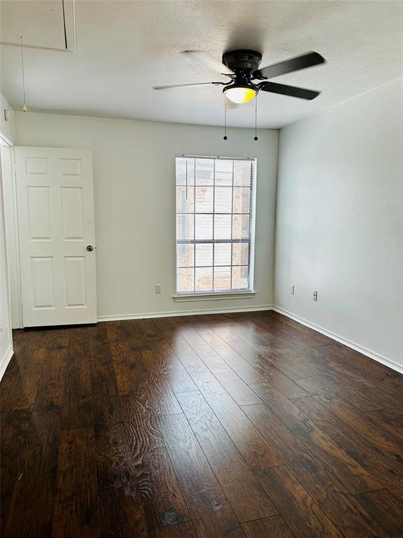 4000 Rawlins Street, Unit 101 Dallas, TX 75219 - Photo 16 of 27 an empty room with wooden floor chandelier fan and windows