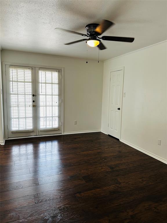 4000 Rawlins Street, Unit 101 Dallas, TX 75219 - Photo 20 of 27 an empty room with wooden floor fan and windows
