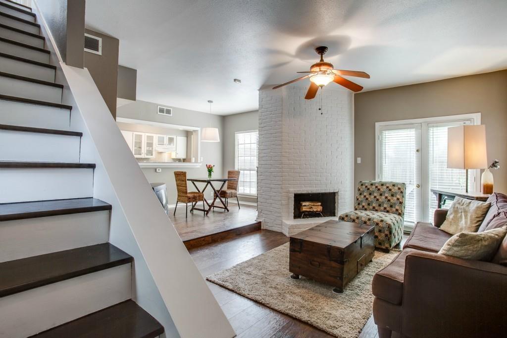 4000 Rawlins Street, Unit 101 Dallas, TX 75219 - Photo 2 of 27 a living room with furniture and a fireplace