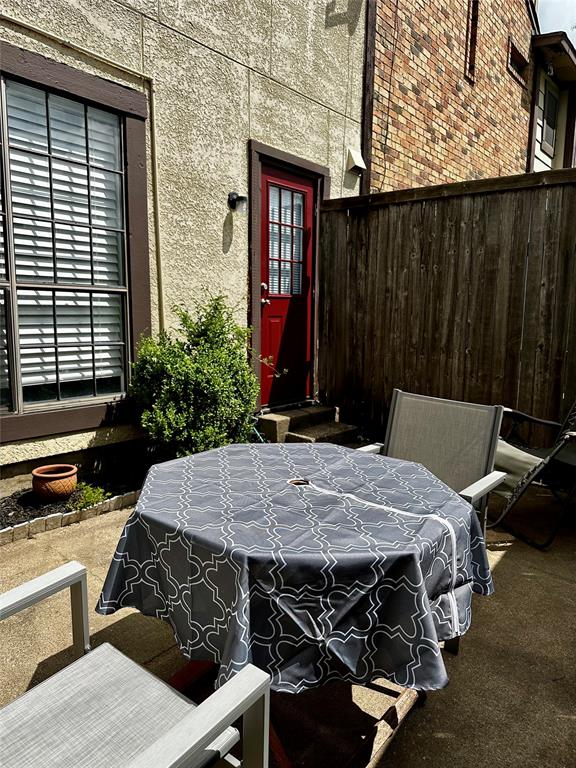 4000 Rawlins Street, Unit 101 Dallas, TX 75219 - Photo 23 of 27 a bed sitting in a bedroom next to a window