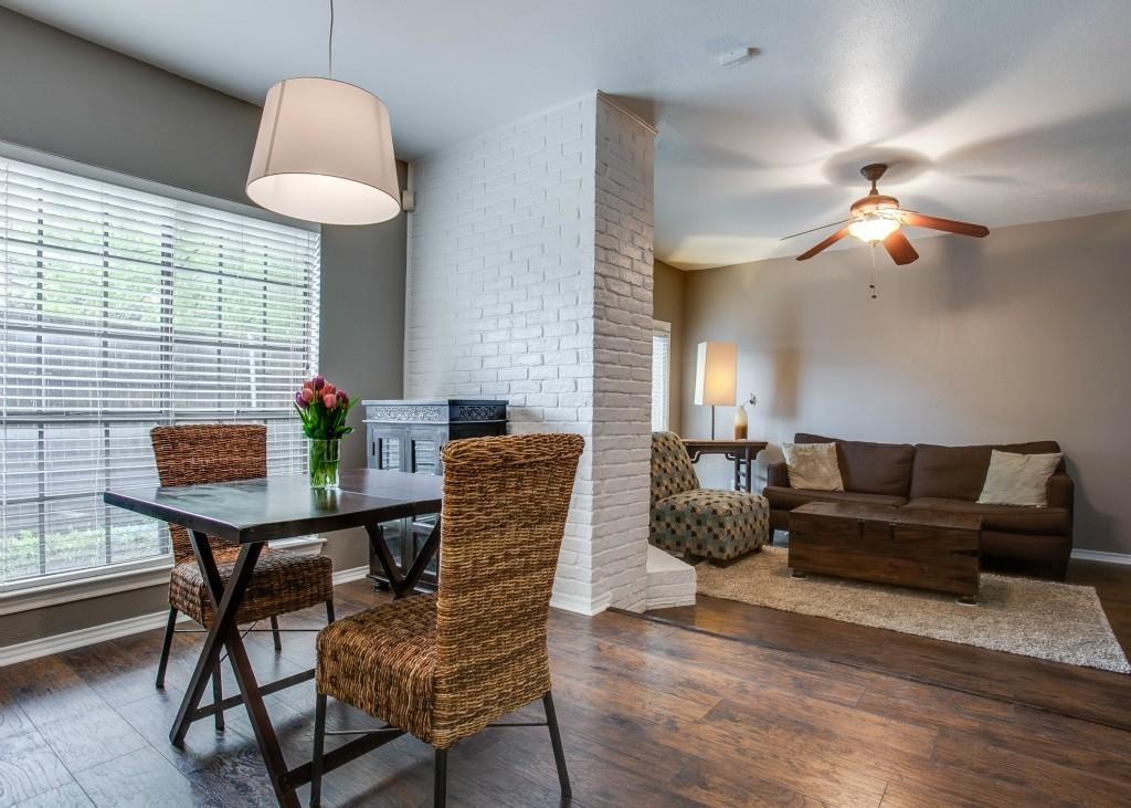 4000 Rawlins Street, Unit 101 Dallas, TX 75219 - Photo 7 of 27 a living room with furniture a chandelier and a window