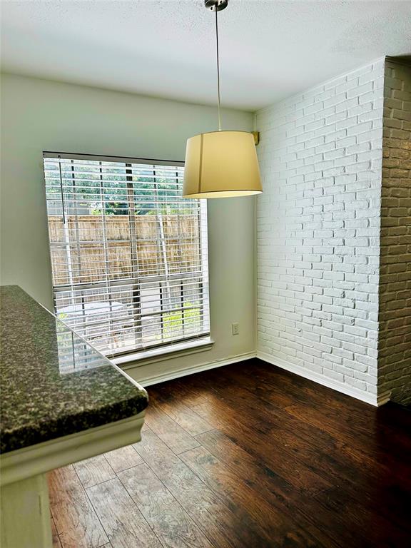 4000 Rawlins Street, Unit 101 Dallas, TX 75219 - Photo 8 of 27 a view of an empty room with wooden floor and a window