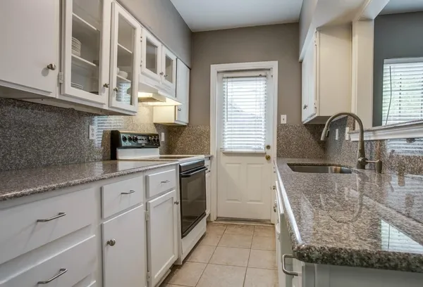 a kitchen with stainless steel appliances granite countertop a sink and cabinets