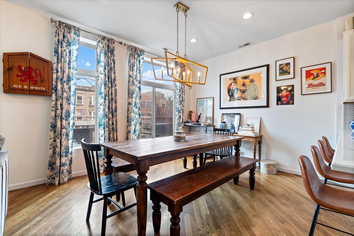 2121 West Division Street, Unit 1 Chicago, IL 60622 - Photo 10 of 18 a view of a dining room with furniture window and wooden floor