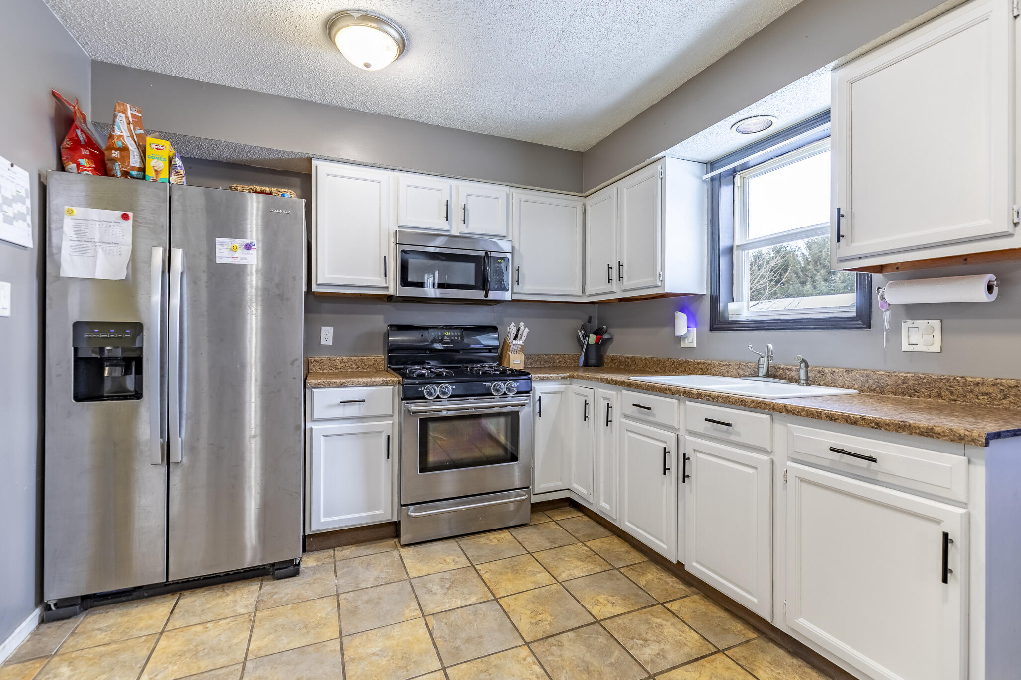 202 South Jefferson Street Hamlet, IN 46532 - Photo 14 of 20 a kitchen with stainless steel appliances granite countertop a refrigerator sink and stove