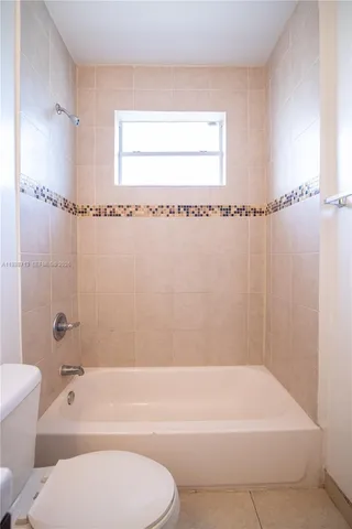 a white bath tub sitting next to a white toilet