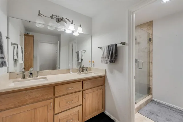 a bathroom with a double vanity sink and mirror
