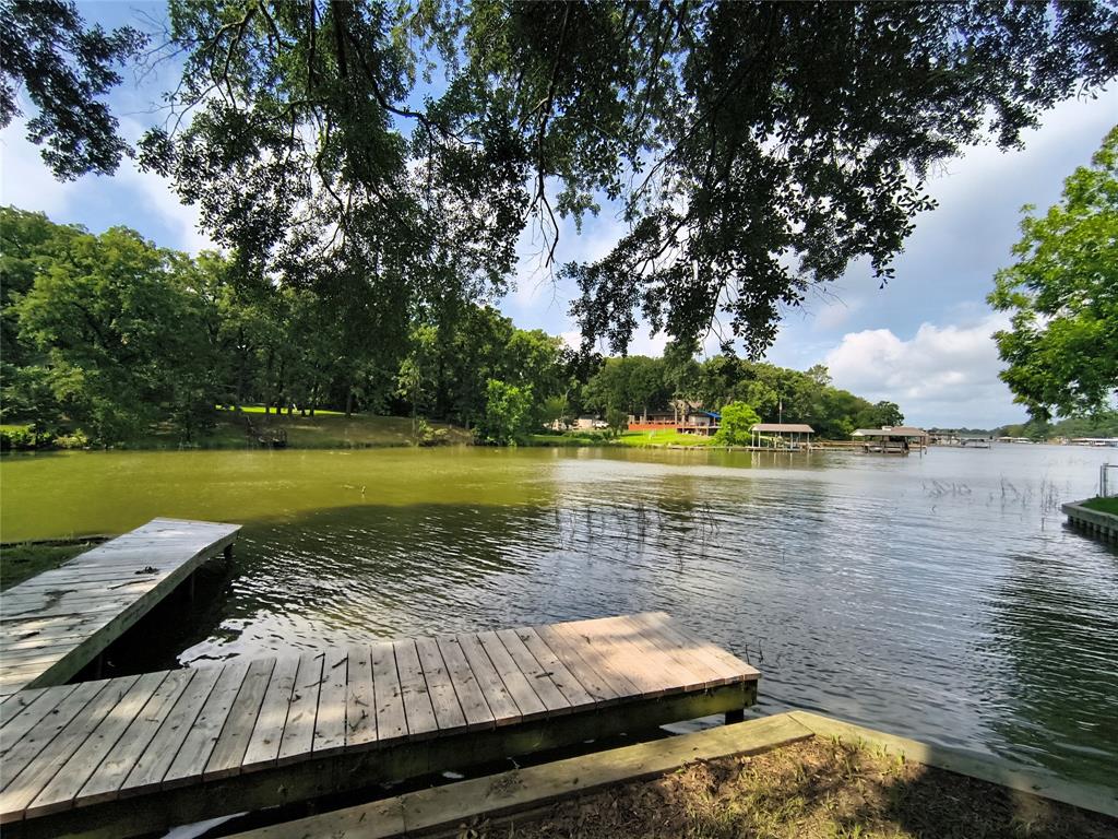 180 Arrowhead Street Mabank, TX 75156 - Photo 19 of 26 a view of a lake with wooden floor and lake view