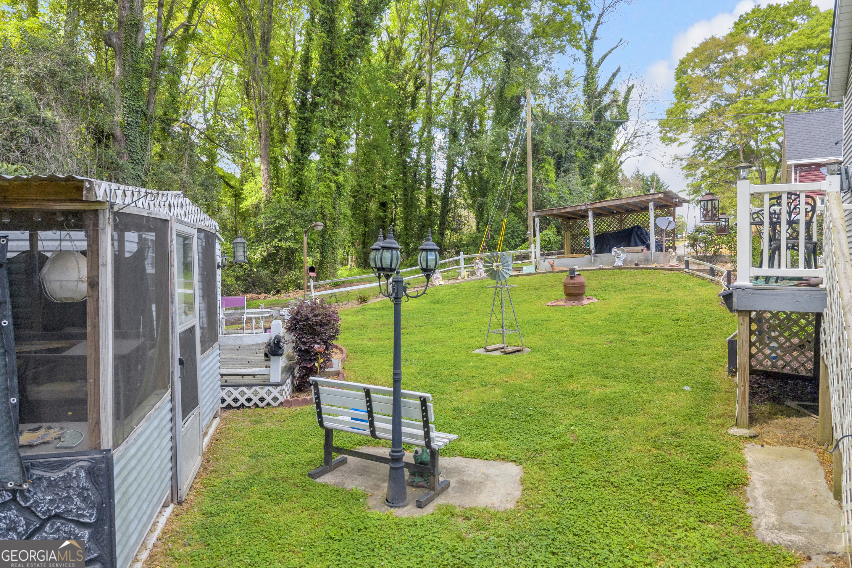 180 Liberty Circle Hartwell, GA 30643 - Photo 25 of 58 a view of a chair and table in backyard of the house