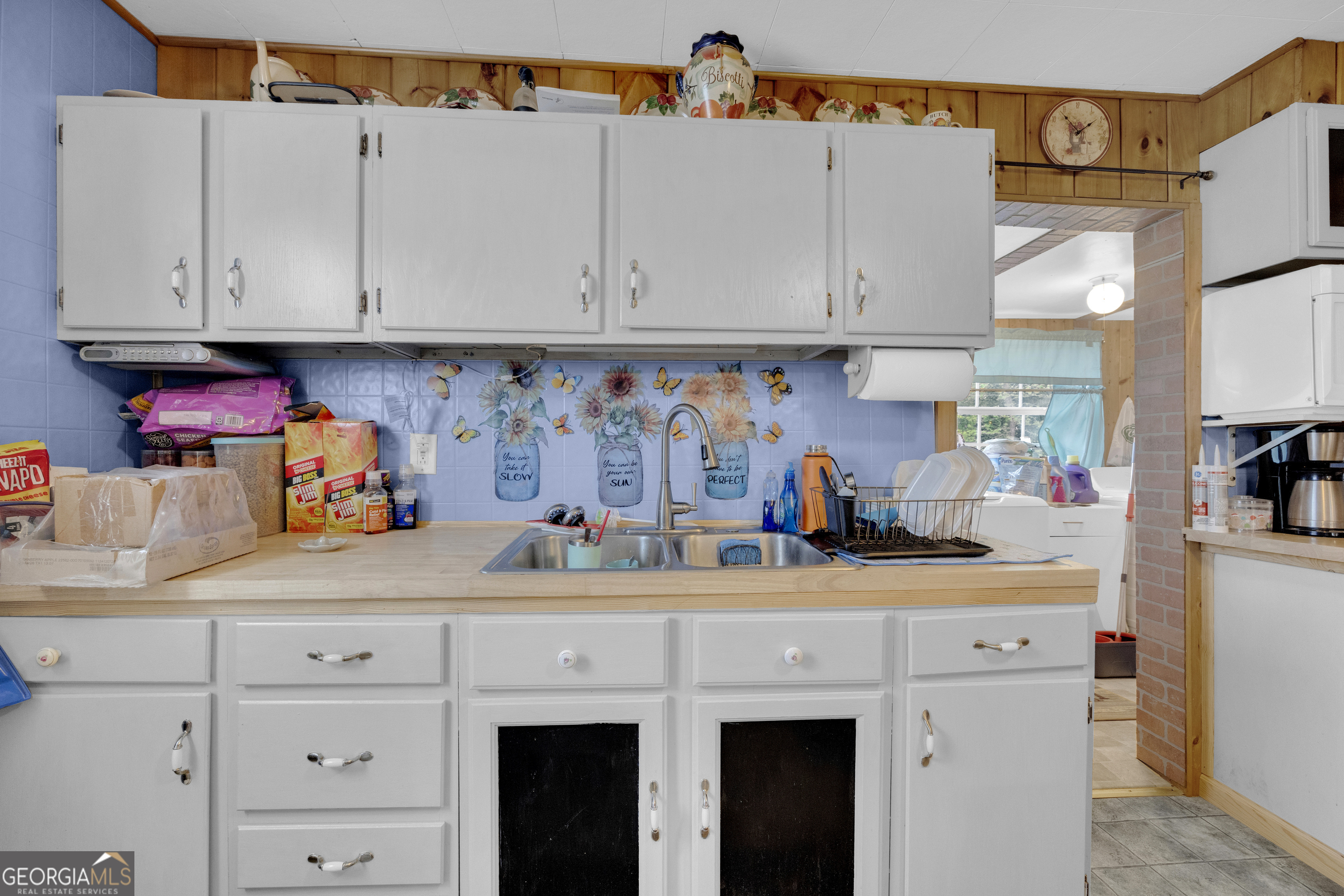 180 Liberty Circle Hartwell, GA 30643 - Photo 45 of 58 a kitchen with white cabinets and white appliances