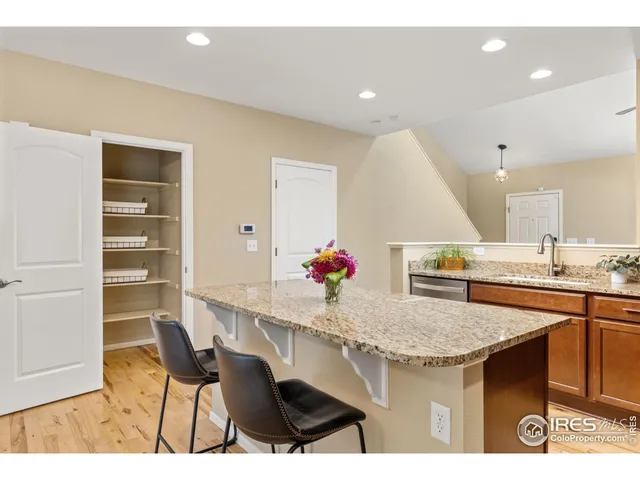 a kitchen with a sink cabinets and wooden floor