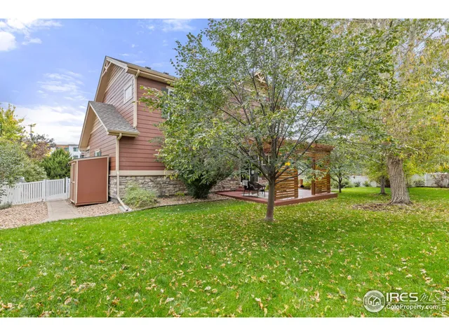 a view of a backyard with large trees