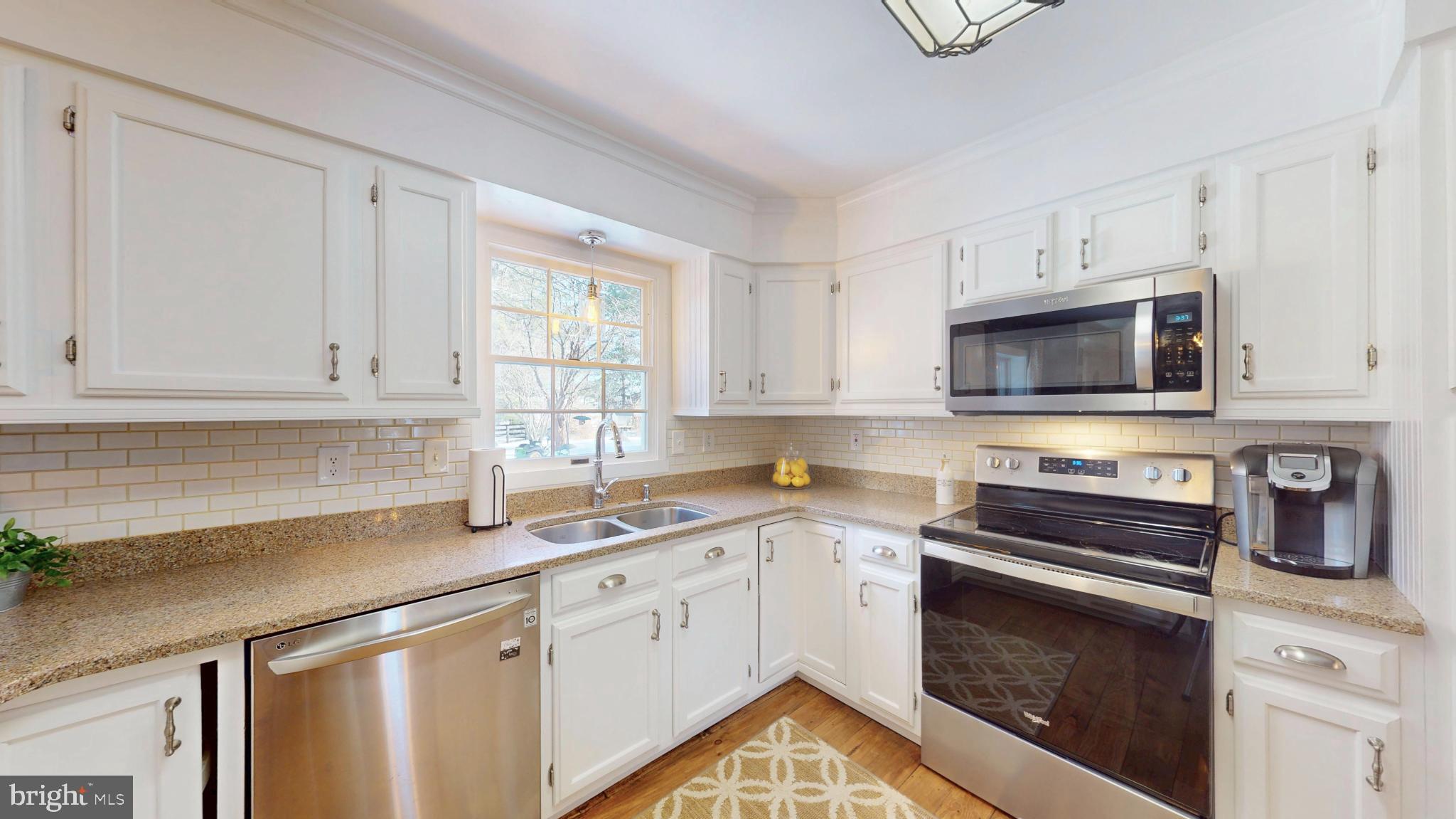 20192 Cockerill Road Purcellville, VA 20132 - Photo 12 of 59 a kitchen with stainless steel appliances a stove a sink and a microwave