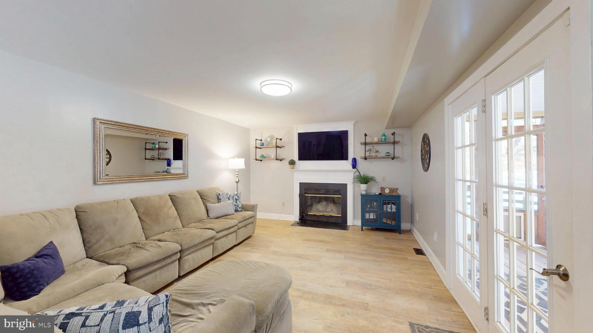 20192 Cockerill Road Purcellville, VA 20132 - Photo 17 of 59 a living room with furniture and a flat screen tv