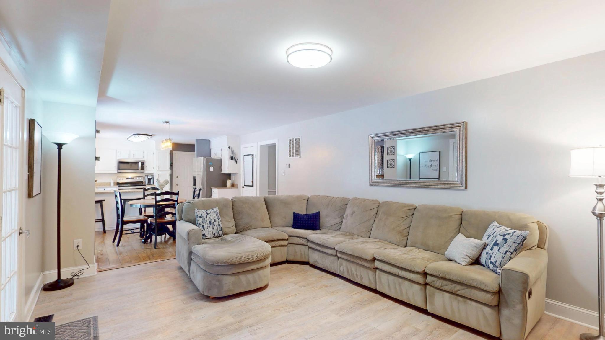 20192 Cockerill Road Purcellville, VA 20132 - Photo 21 of 59 a living room with furniture and a dining table with bookshelf