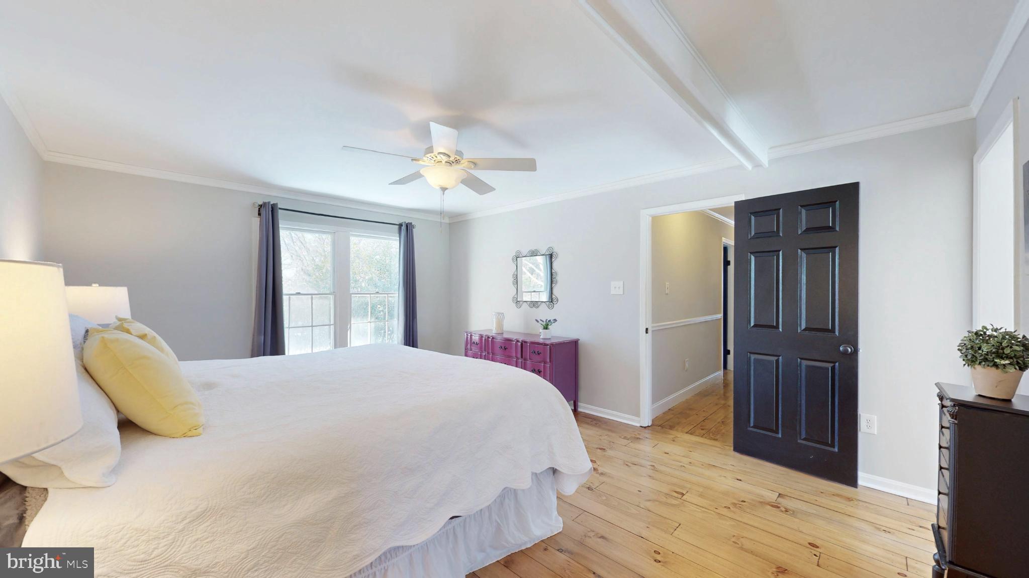 20192 Cockerill Road Purcellville, VA 20132 - Photo 24 of 59 a bedroom with a bed and a chandelier