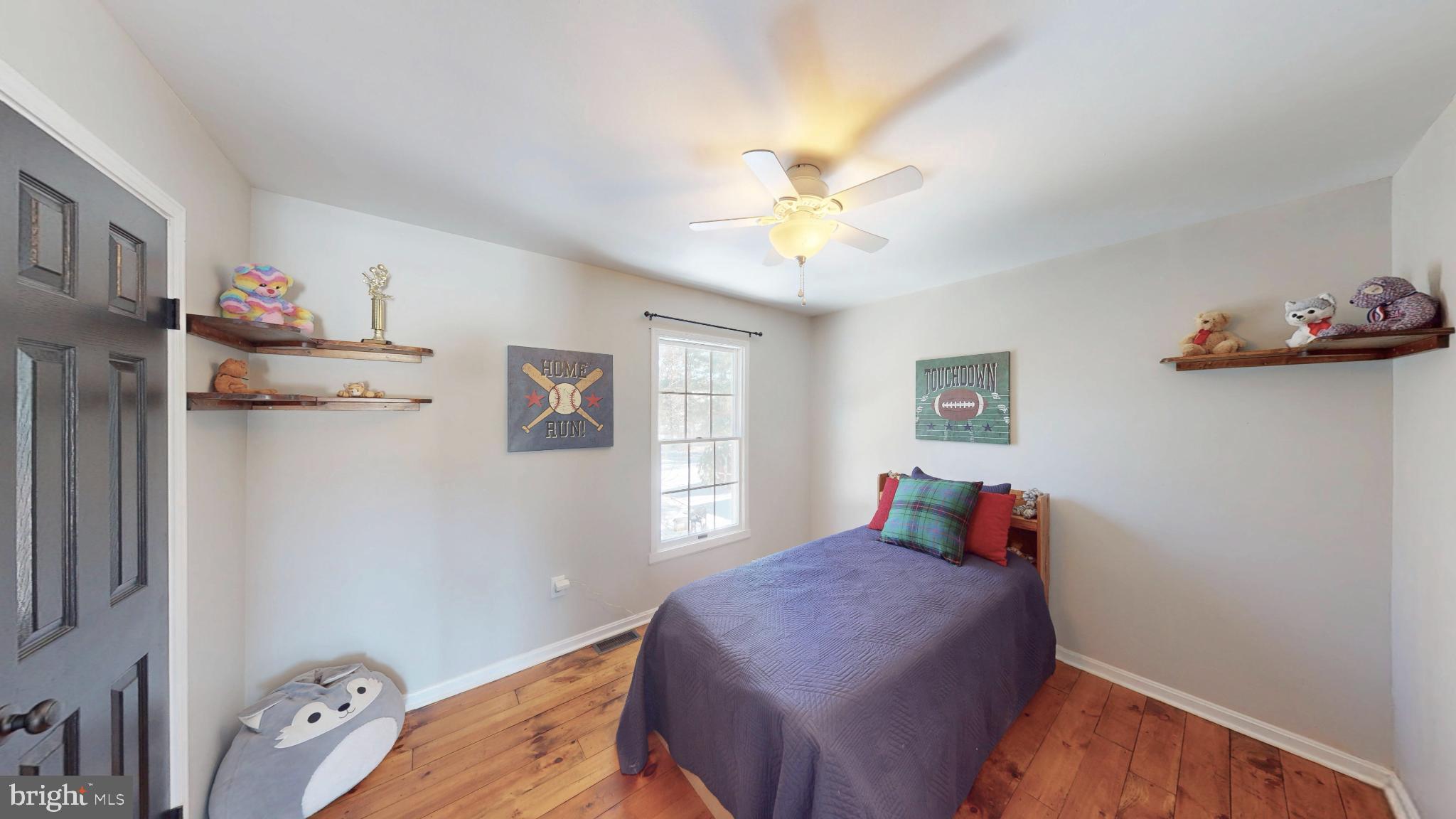 20192 Cockerill Road Purcellville, VA 20132 - Photo 32 of 59 a bedroom with a bed and a chandelier