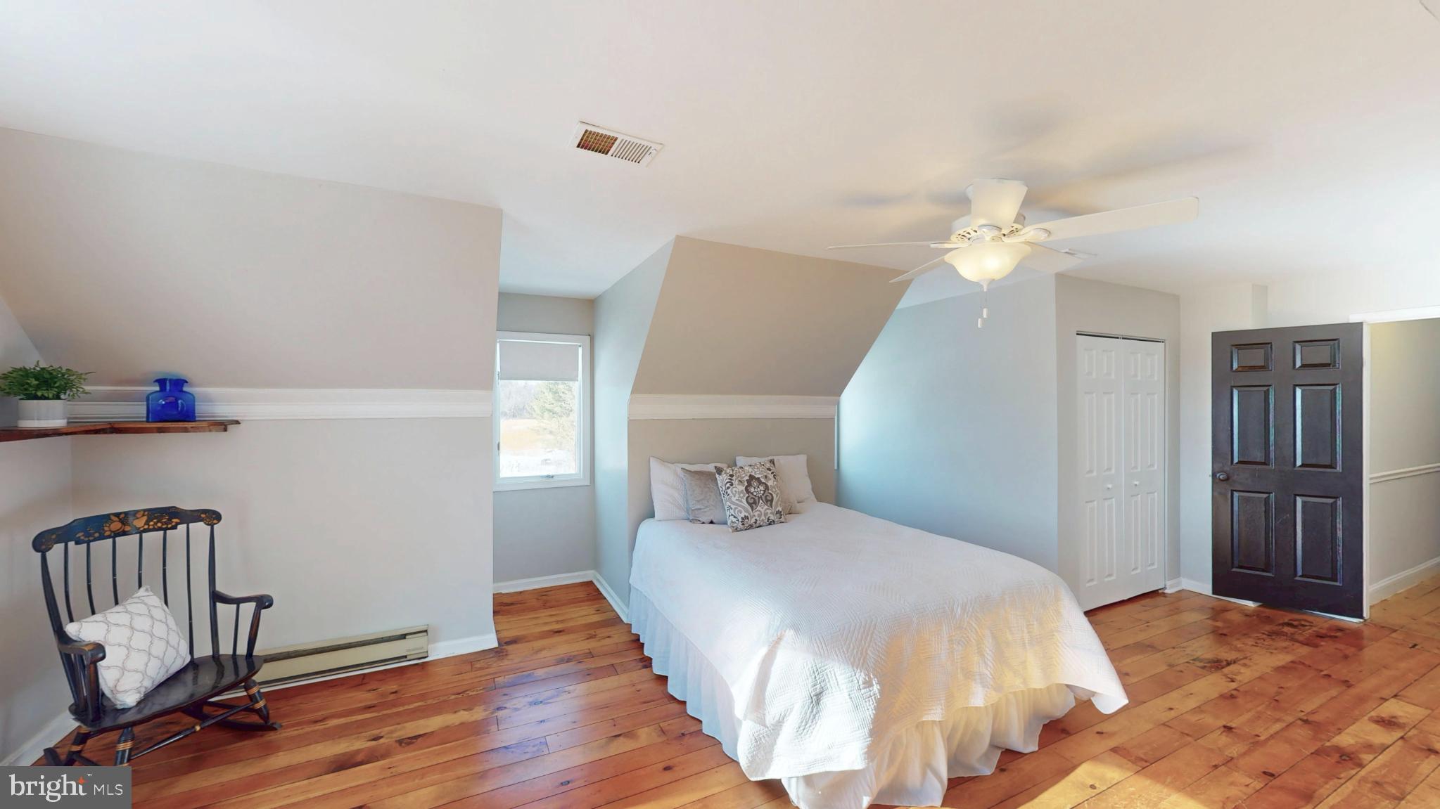 20192 Cockerill Road Purcellville, VA 20132 - Photo 39 of 59 a bedroom with a bed and wooden floor