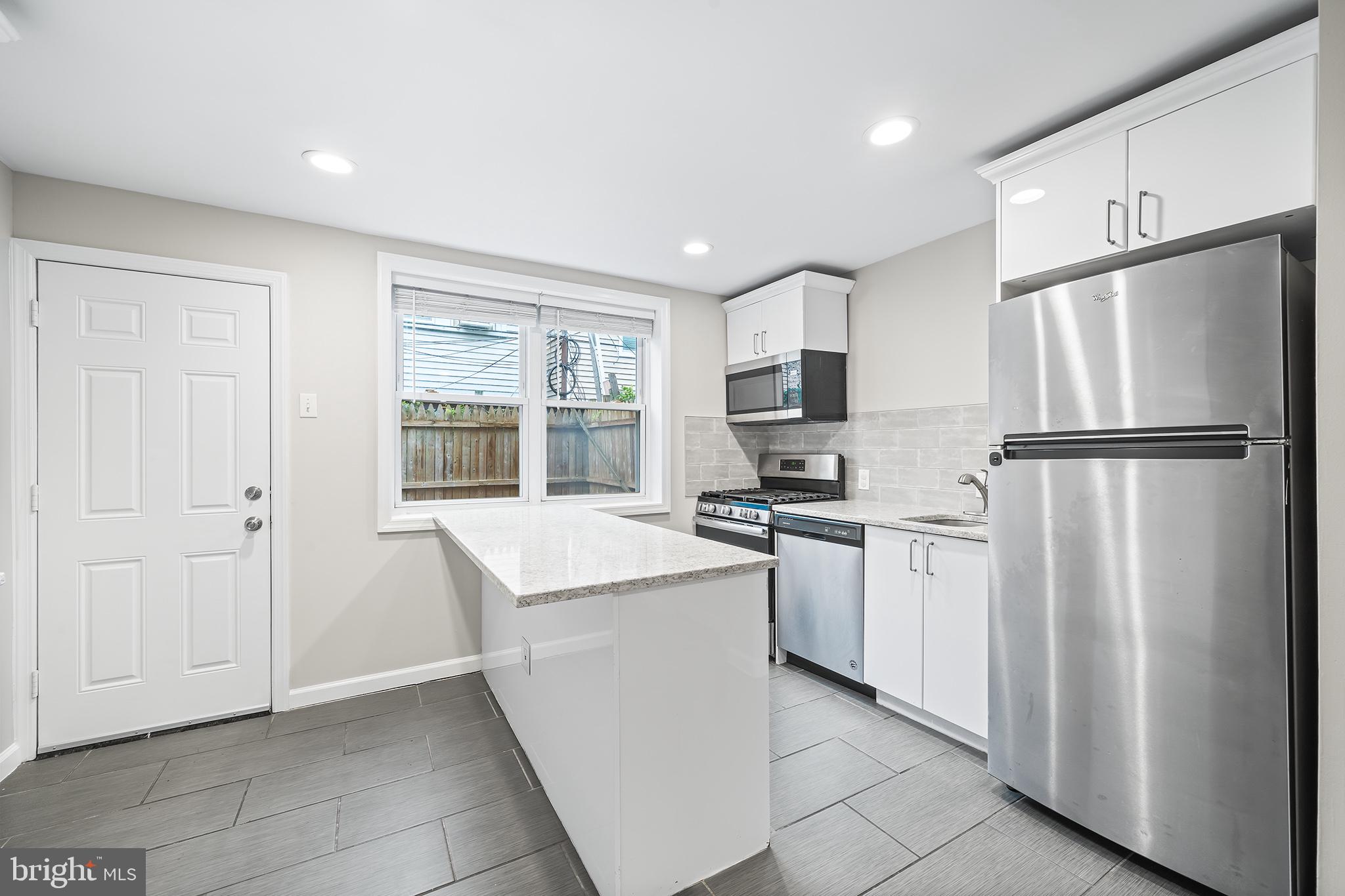 618 McClellan Street Philadelphia, PA 19148 - Photo 12 of 41 a kitchen with white cabinets and refrigerator
