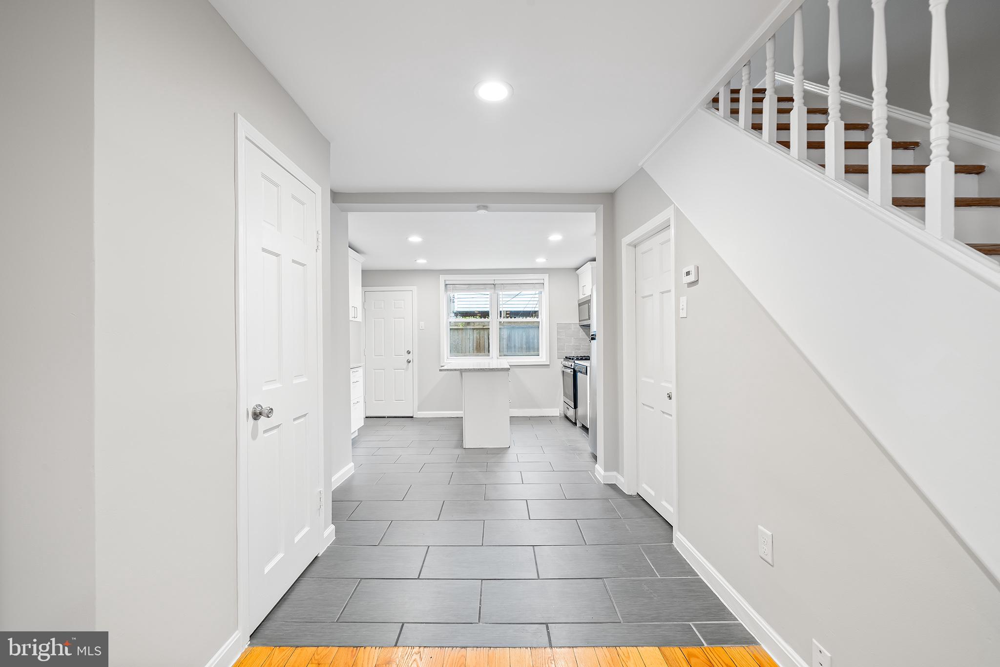 618 McClellan Street Philadelphia, PA 19148 - Photo 16 of 41 a view of a hallway with wooden floor and windows