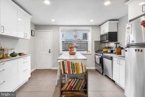 a kitchen with cabinets and window