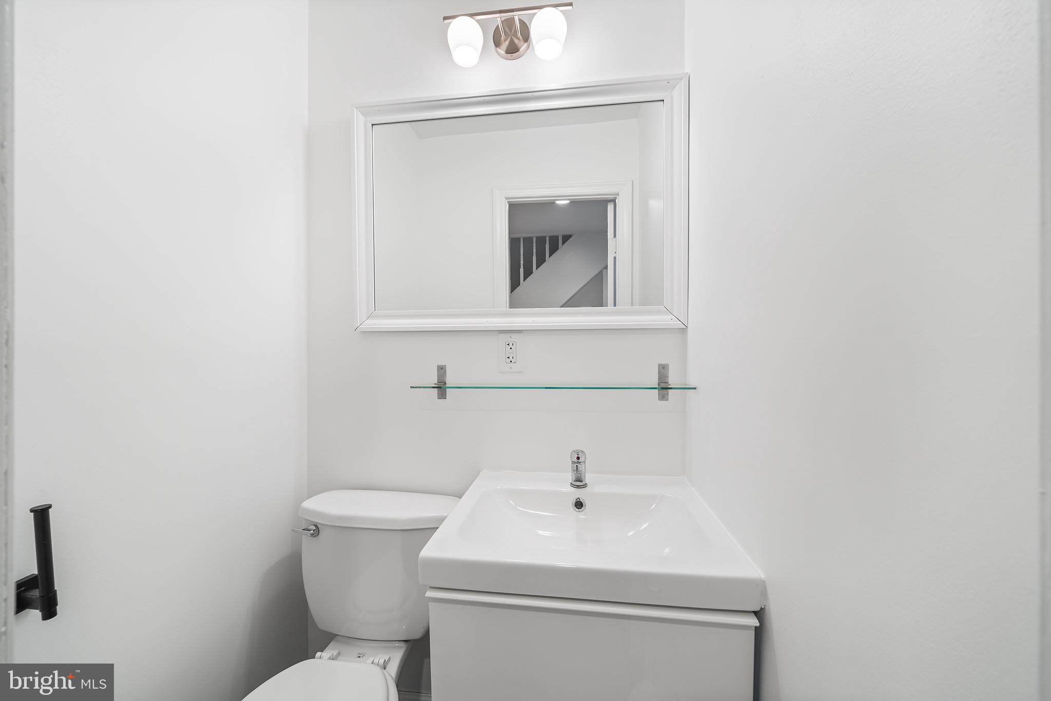 618 McClellan Street Philadelphia, PA 19148 - Photo 21 of 41 a bathroom with a toilet sink and mirror