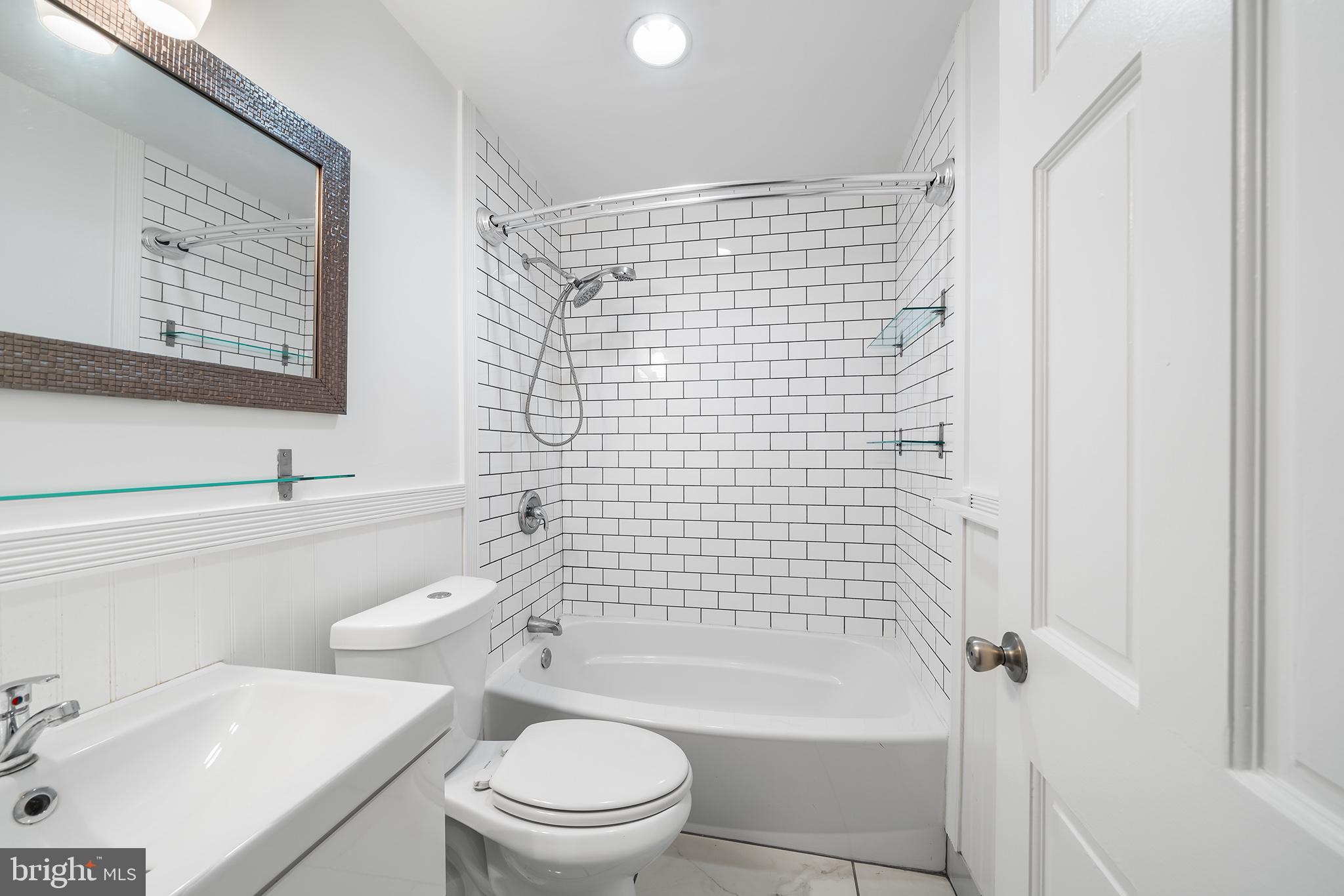 618 McClellan Street Philadelphia, PA 19148 - Photo 35 of 41 a bathroom with a sink a toilet and shower