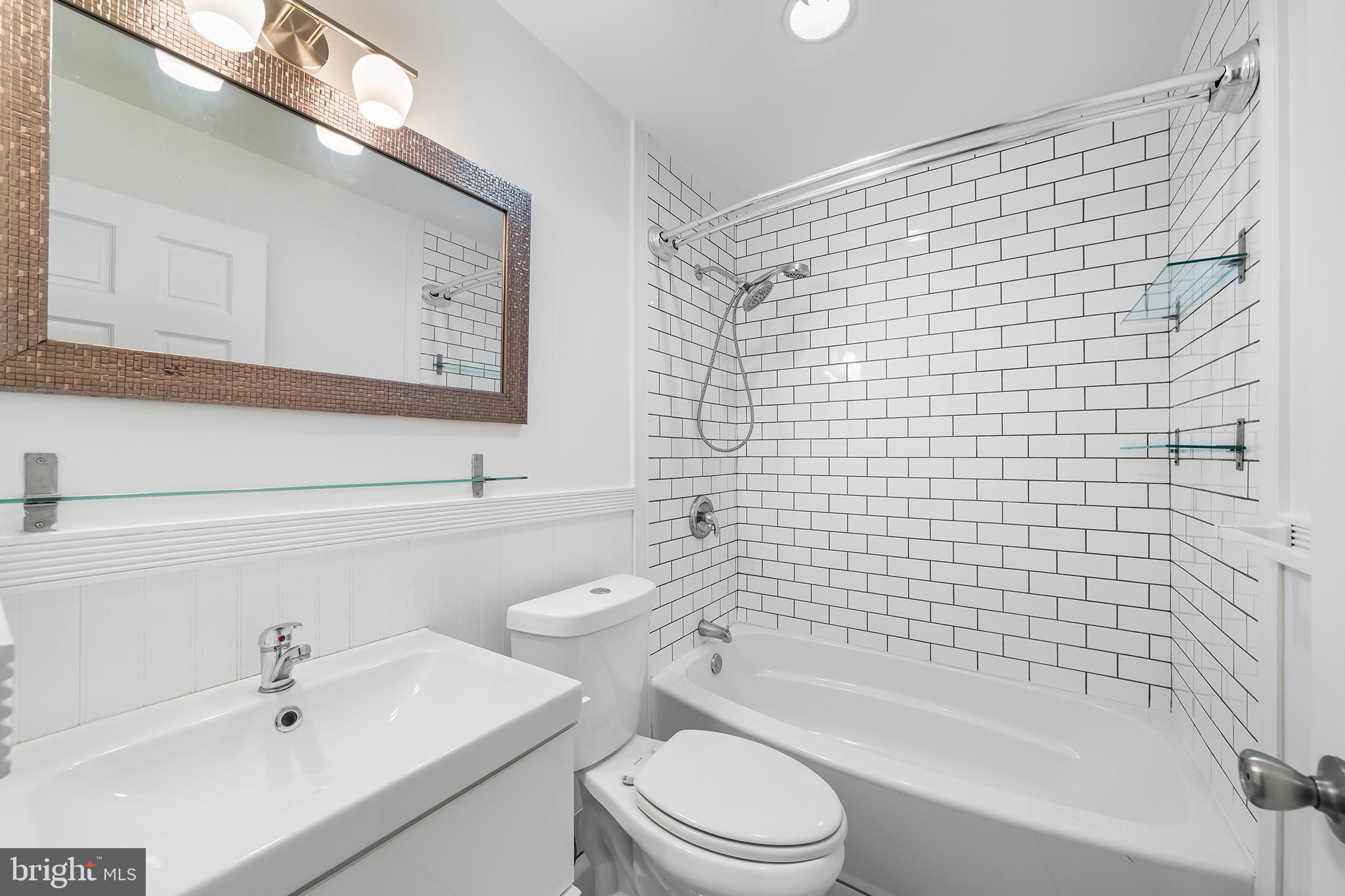 618 McClellan Street Philadelphia, PA 19148 - Photo 36 of 41 a bathroom with a bathtub shower sink vanity and toilet