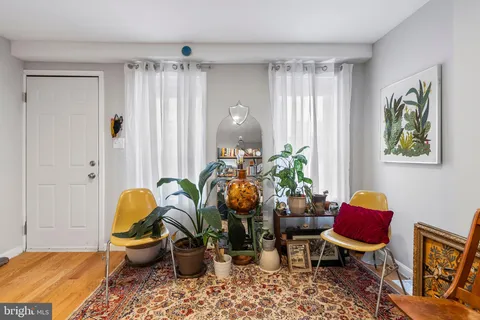 a living room filled with furniture and a window