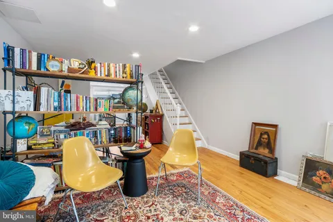 a living room with lots of furniture and a book shelf