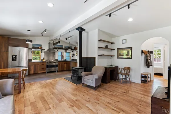 a living room with fireplace furniture and a wooden floor