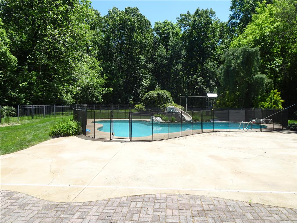 1371 Stoke Park Road Bethlehem, PA 18017 - Photo 3 of 12 An inviting backyard oasis offers a sparkling pool surrounded by mature trees.