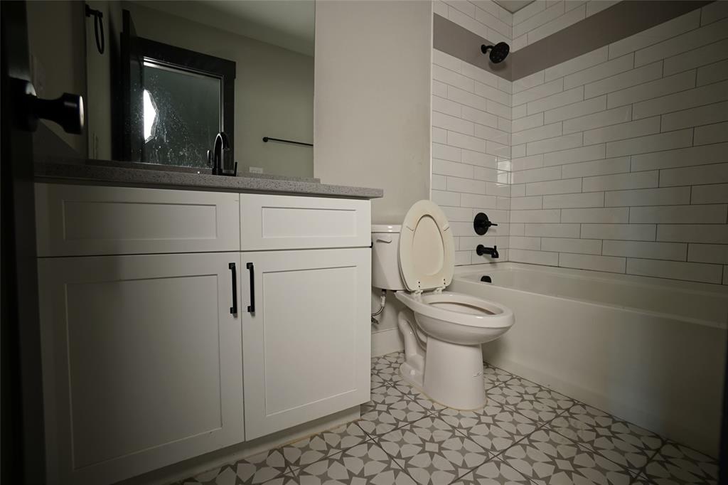 1764 Palladio Loop Princeton, TX 75407 - Photo 27 of 40 Bathroom featuring a white vanity with flat-panel cabinetry, a dark countertop, and matte black hardware