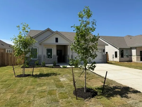 a white house with a yard and sitting space